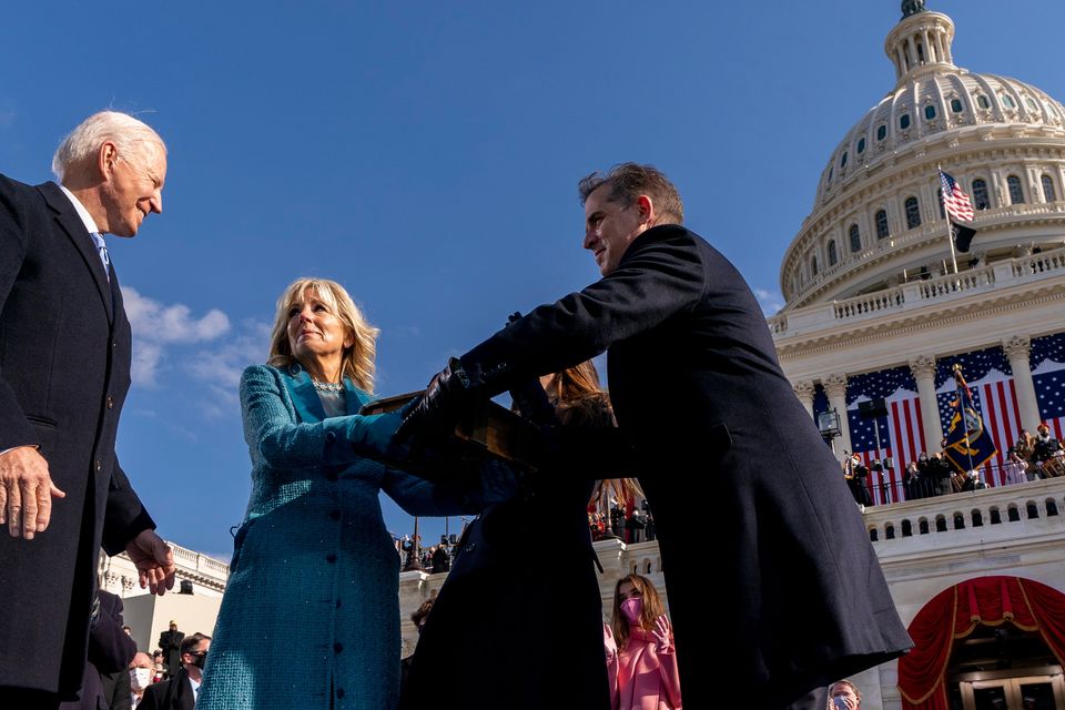 Family affair: Joe Biden turns to kiss first lady Jill Biden as son Hunter takes the 127-year-old Biden Bible at Wednesday’s inauguration