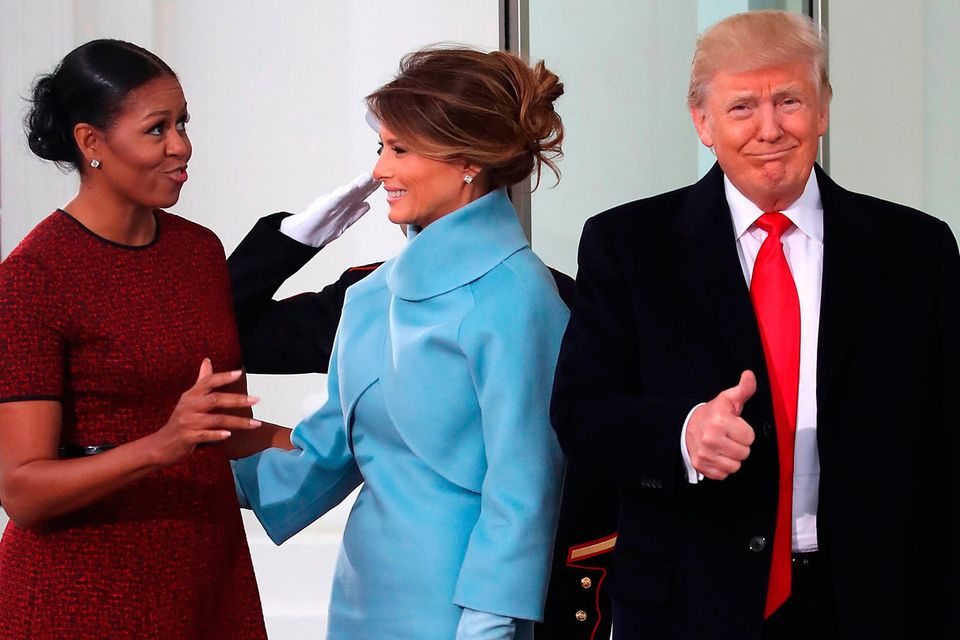 President-elect Donald Trump gives a thumbs up, as his wife Melania Trump (C), first lady Michelle Obama, upon arriving at the White House on January 20, 2017 in Washington, DC. Later in the morning President-elect Trump will be sworn in as the nation's 45th president during an inaugural ceremony at the U.S. Capitol.   (Photo by Mark Wilson/Getty Images)