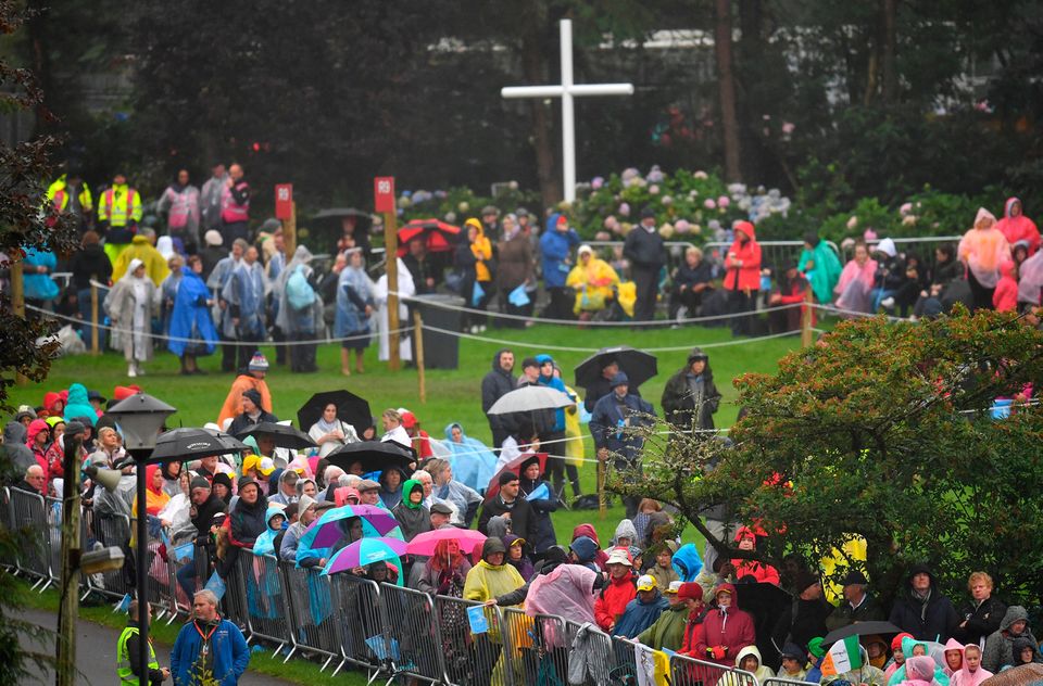 The faithful wait in the rain ahead of a visit from Pope Francis to Knock Shrine. REUTERS/Dylan Martinez