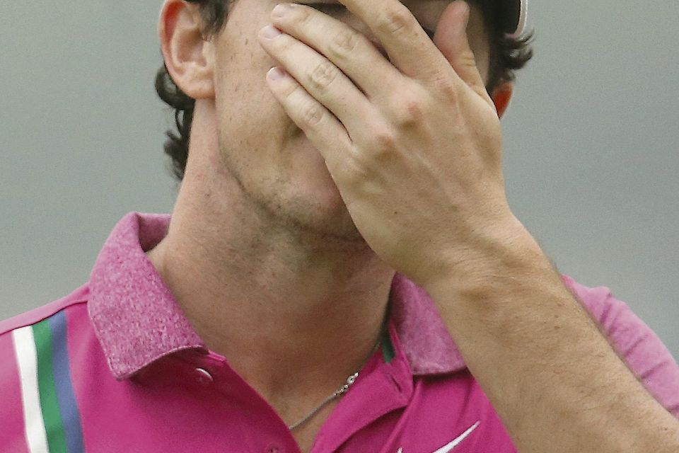 Rory McIlroy of Northern Ireland wipes his face after finishing the HSBC Champions golf tournament at the Sheshan International Golf Club in Shanghai. Photo: AP/Eugene Hoshiko