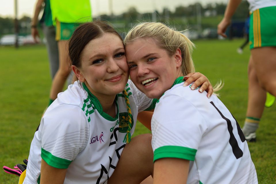 Kilcoole's Ella Mackey and Robyn Evans share a moment after the final whistle. 