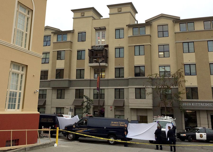 Police hold up sheets as medical staff take away the bodies of the dead students at the Library Gardens apartment complex in Berkeley.