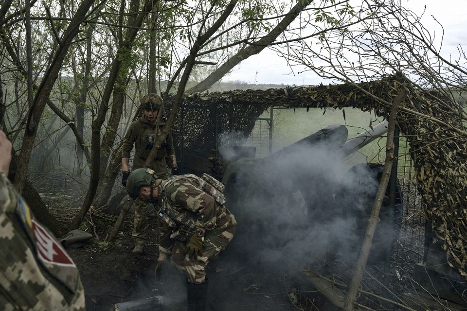 Ukrainian soldiers fire near Bakhmut in the Donetsk region (Libkos/AP)