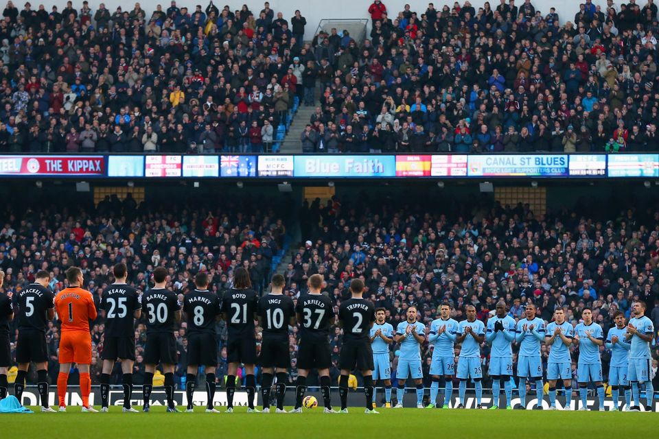 The players observe a minutes applause during the Barclays Premier League match between Manchester City and Burnley at Etihad Stadium