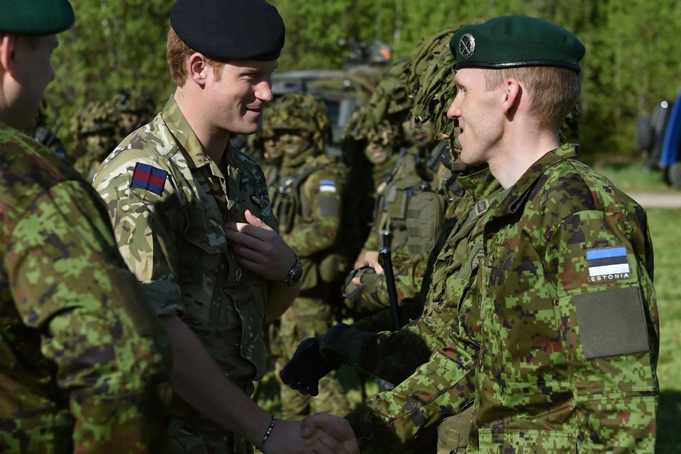 Prince Harry (centre) is introduced to Captain Tanel Tarlap (right), who he served alongside during his tour of Aghanistan in 2008, at a military exercise in Sangaste