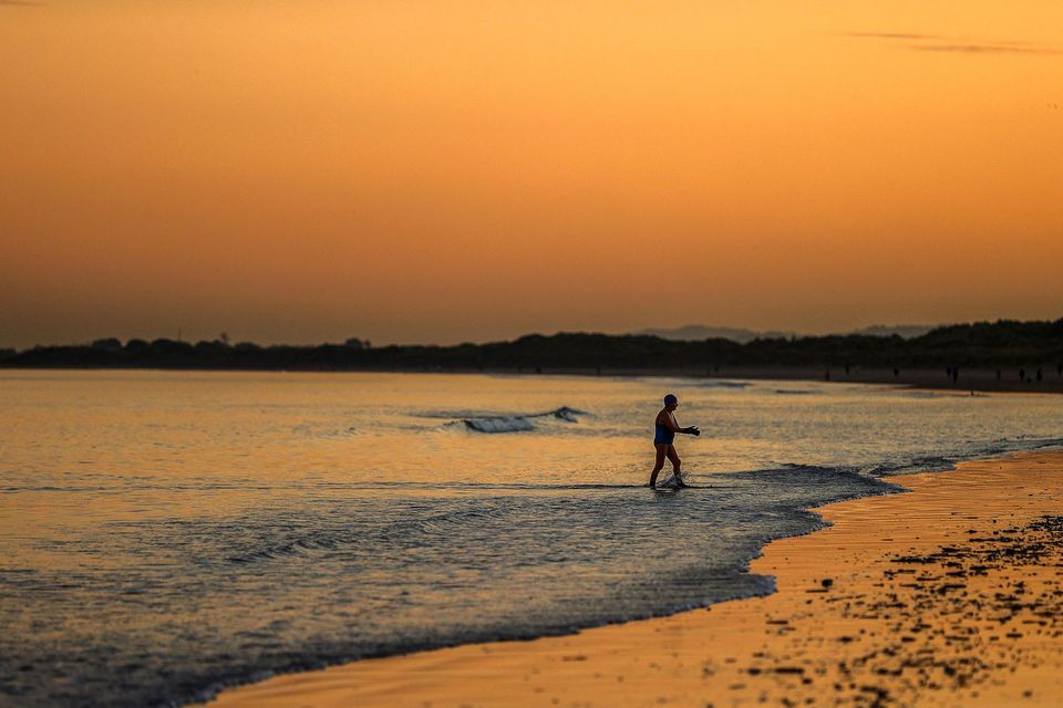 People enjoy going for a dip at Portmarnock Strand, Co Dublin. Photo: Gerry Mooney
