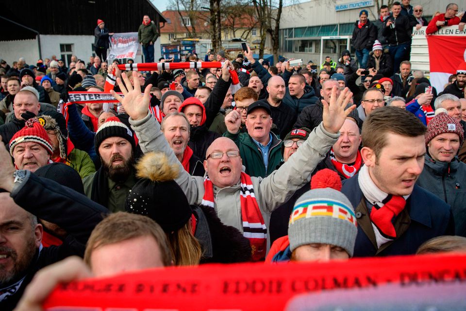 Soccer fans attend a commemoration ceremony on the Manchester place at the Munich Riem airport, southern Germany, Tuesday, Feb. 6, 2018. Sixty years ago on Feb. 6, 1958 a plane with professional players of the Manchester United soccer club on board crashed in Munich with 21 survivors and 23 fatalities. (Matthias Balk/dpa via AP)