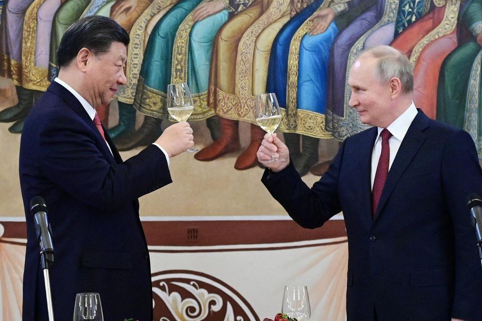 Vladimir Putin and Xi Jinping attend a reception at the Kremlin yesterday. Photo: Pavel Byrkin