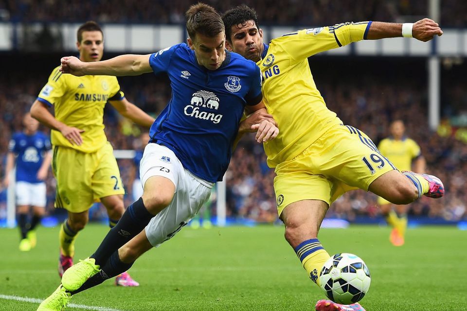 Diego Costa of Chelsea tackles Seamus Coleman of Everton