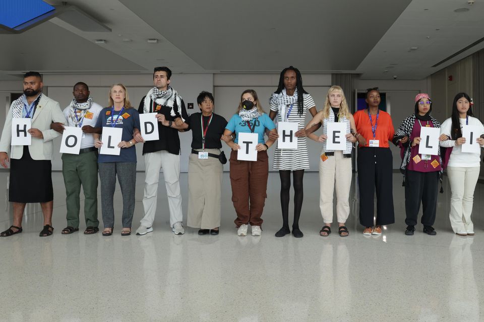 Activists protest by holding letters that read: "Hold the line" on day eleven of the UNFCCC COP28 Climate Conference as negotiations go into their final phase. Photo: Sean Gallup/Getty.