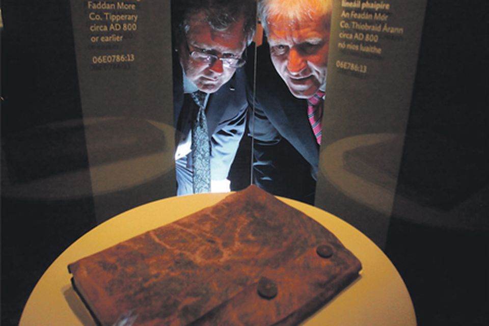 Jimmy Deenihan
(right) and Dr Patrick
Wallace, director of
the National
Museum, view the
Psalter yesterday