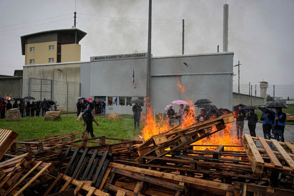 Prison workers protest in front of the Corbas prison outside Lyon, France yesterday. Photo: AP