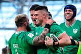 thumbnail: Dan Sheehan of Ireland, centre, celebrates with team-mate Andrew Porter, left, after scoring their side's fourth try
