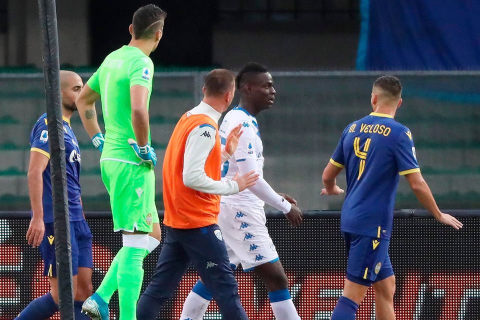 Brescia's Mario Balotelli, second from right, reacts to Verona supporters' racist chants