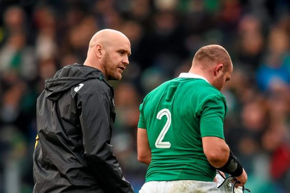 Rory Best, Ireland, leaves the field accompanied by Dr. Eanna Falvey, team doctor