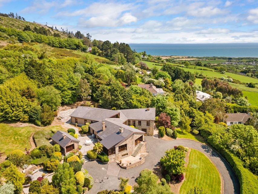 An aerial view of the house with the sea in the near distance