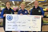 thumbnail: Glencormac United Ladies players and Tesco Bray employees Kathie Browne and Lindsay Martin receiving a cheque from Tesco Vevay Road Store Manager Audrey Sutton.