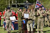 thumbnail: Prince Harry (centre right) clapping as members of the Estonia army are awarded commendations on behalf of Brigadier James Woodham at a military exercise in Sangaste