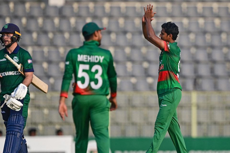 Bangladesh's Hasan Mahmud (r) celebrates after taking the wicket of Ireland's Curtis Campher (l) during the third and final one-day international (ODI) cricket match in Sylhet.
