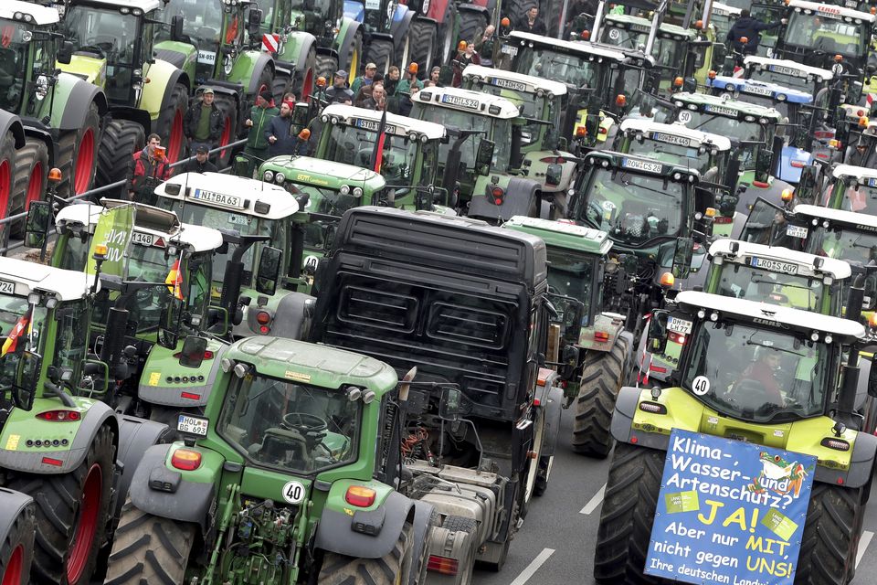 Farmers parked at the Brandenburg Gate in Berlin (Michael Sohn/AP)