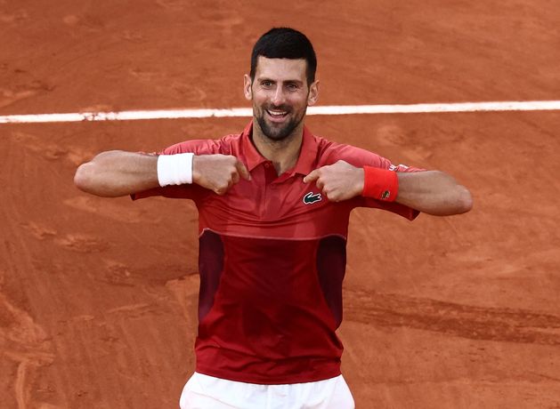 Novak Djokovic battles back to set Grand Slam winning record