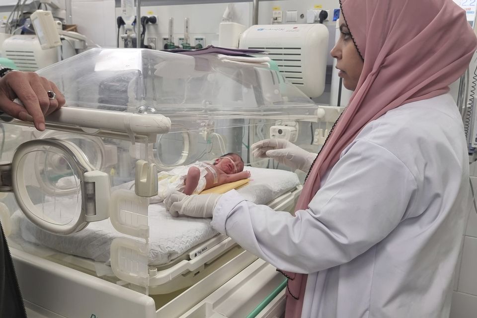A Palestinian baby girl, Sabreen Jouda, who was delivered prematurely after her mother was killed in an Israeli strike, lies in an incubator in the Emirati hospital (Mohammad Jahjouh/AP)