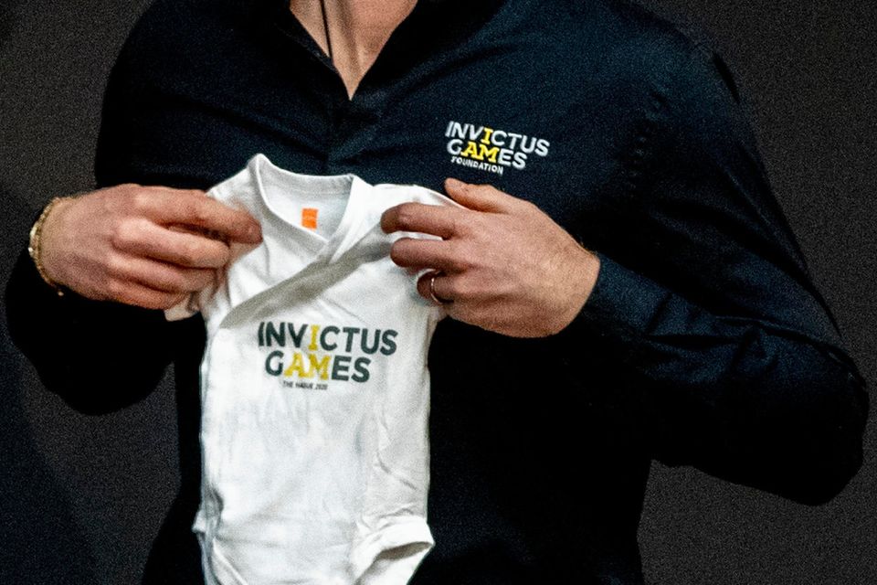 Prince Harry, Duke of Sussex is presented with an Invictus Games baby grow for his newborn son Archie by Princess Margriet of The Netherlands during the launch of the Invictus Games on May 9, 2019 in The Hague, Netherlands. (Photo by Patrick van Katwijk/Getty Images)