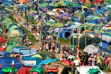 thumbnail: Revellers walk along a pathway surrounded by tents at the Glastonbury Festival of Music and Performing Arts on Worthy Farm near the village of Pilton in Somerset, South West England, on June 26, 2019. (Photo by Oli SCARFF / AFP)OLI SCARFF/AFP/Getty Images