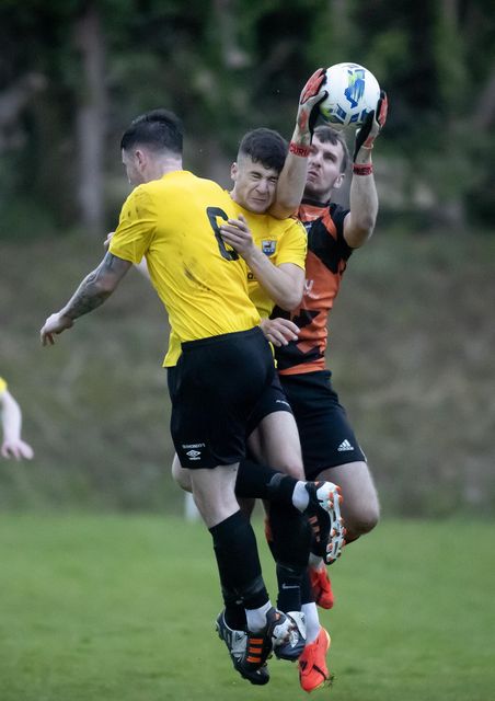 Rosslare Rangers goalkeeper Joshua Burke gathers the ball.