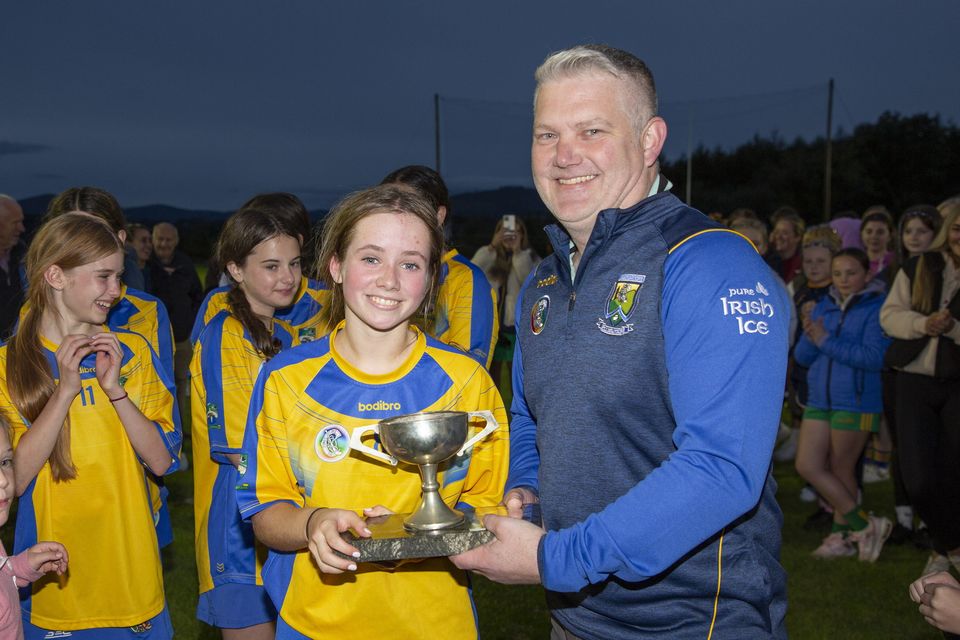 Ivor Lehane presents the Wicklow Under-14 'A' camogie championship trophy to Annacurra captain Danielle Shannon.  