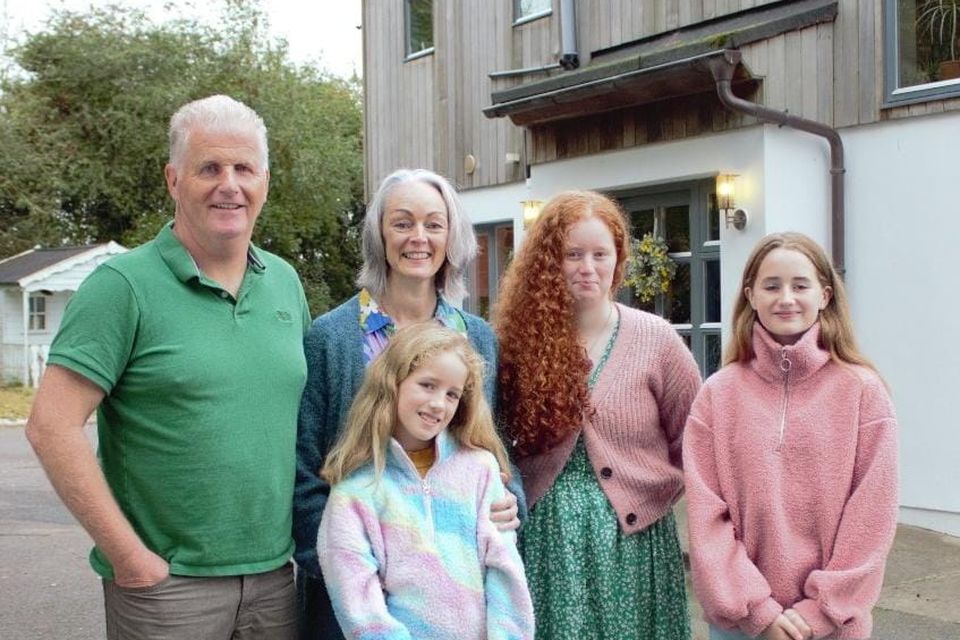 Peter and Olivia Phillips with their three girls outside their eclectic self-build in Co Louth for RTÉ's Home of the Year
