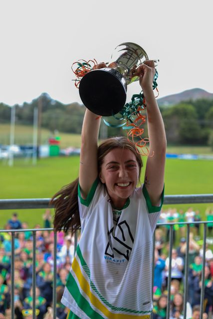 Kilcoole captain Lucy Phipps Rooney lifts the cup high. 