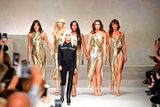 thumbnail: Top models (from left) Carla Bruni, Claudia Schiffer, Naomi Campbell, Cindy Crawford and  Helena Christensen walk the runway with Italian designer Donatella Versace (C) at the end of the show for fashion house Versace during the Women's Spring/Summer 2018 fashion shows in Milan, on September 22, 2017.  / AFP PHOTO / Miguel MEDINAMIGUEL MEDINA/AFP/Getty Images