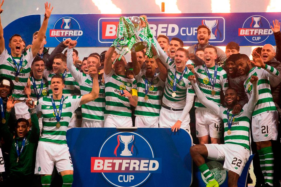 CHAMPIONS: Celtic players and staff celebrate with the Betfred Cup trophy after their win over Aberdeen. Pic: PA Wire