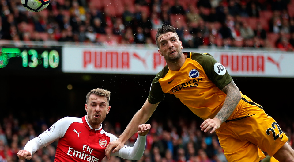 Shane Duffy of Brighton and Hove Albion headers the ball away from Aaron Ramsey. Photo: Getty Images