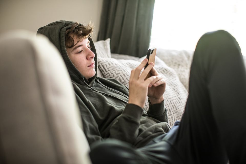 Young people are becoming addicted to wasting time scrolling on their phones. Stock image