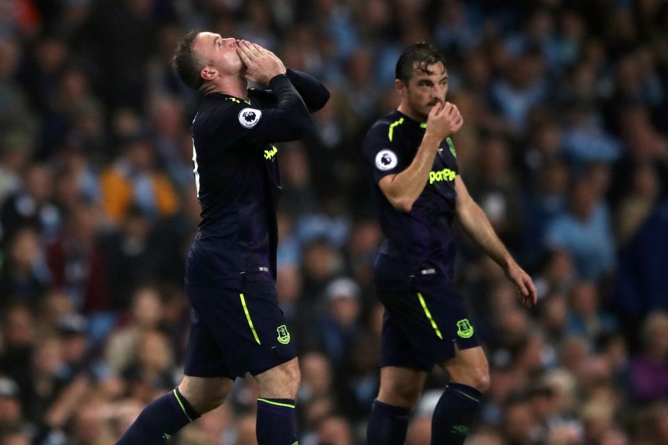 Wayne Rooney, left, celebrates scoring his 200th Premier League goal