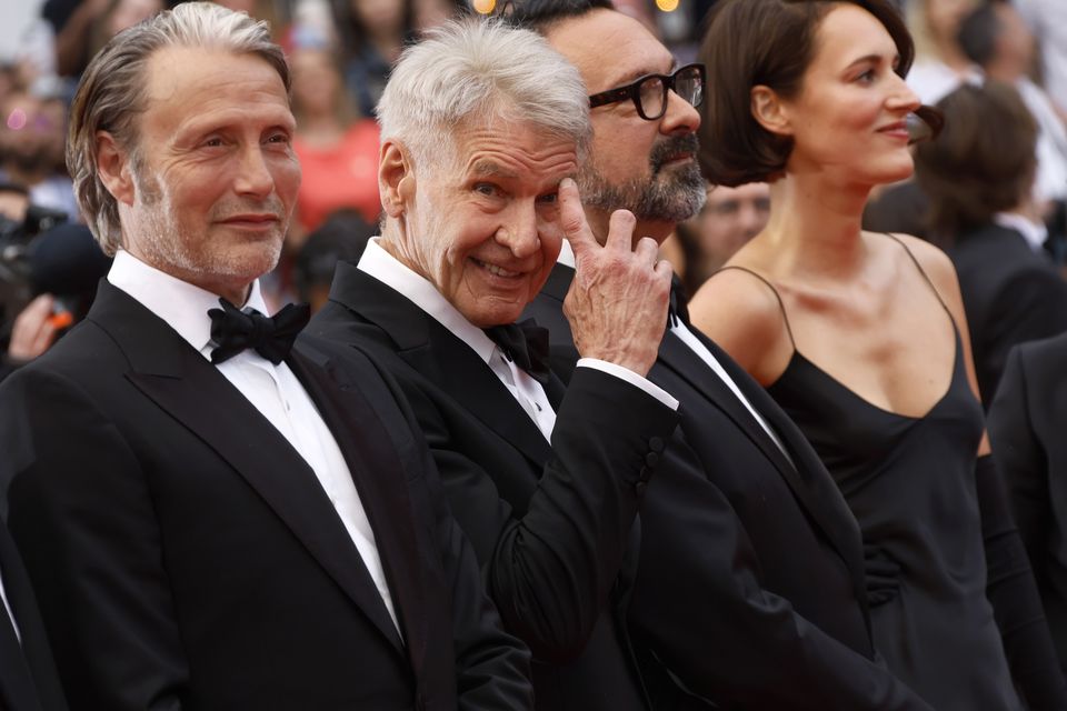 Ford paid tribute to co-stars Mads Mikkelsen, left, and Phoebe Waller-Bridge, right (Joel C Ryan/Invision/AP)