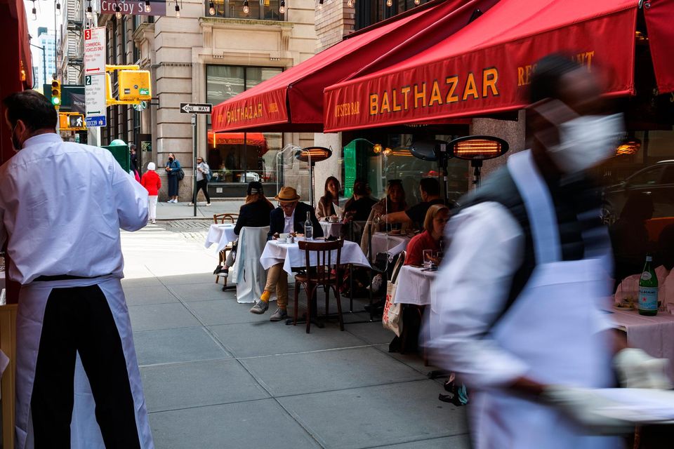 Customers dine on the outdoor patio of Balthazar restaurant in New York, US. Photo: Bloomberg / Paul Frangipane