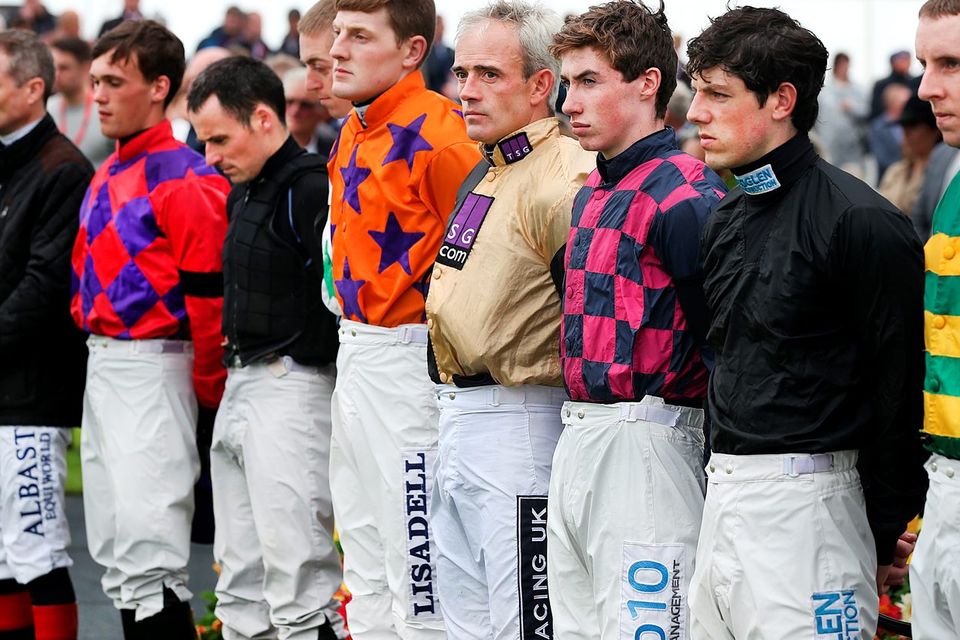 Jockeys including Ruby Walsh in the parade ring at the Galway Races observe a minutes silence for Jockey J T. McNamara who passed away. Photo: Steve Humphreys