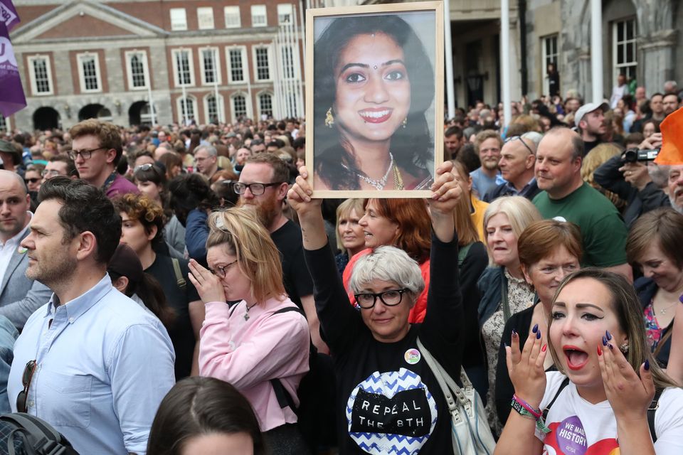 A supporter holds a photo of Savita Halappanavar (Niall Carson/PA)