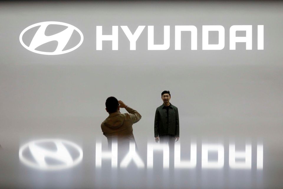 File image shows visitors taking photographs in front of the logo of Hyundai during the 2019 Seoul Motor Show in Goyang, South Korea. Photo: Reuters/Kim Hong-Ji/File Photo