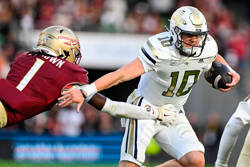 24 August 2024; Georgia Tech Yellow Jackets quarterback Haynes King is tackled by Florida State Seminoles defensive back Shyheim Brown during the 2024 Aer Lingus College Football Classic match between Florida State and Georgia Tech at Aviva Stadium in Dublin. Photo by Brendan Moran/Sportsfile 