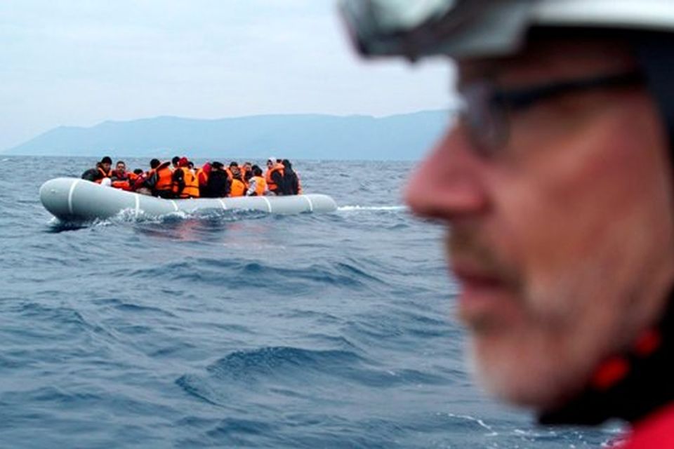 A German rescuer volunteer escorts with his vessel a dinghy with refugees and migrants as they arrive from the Turkish coast to the northeastern Greek island of Lesbos. File picture.