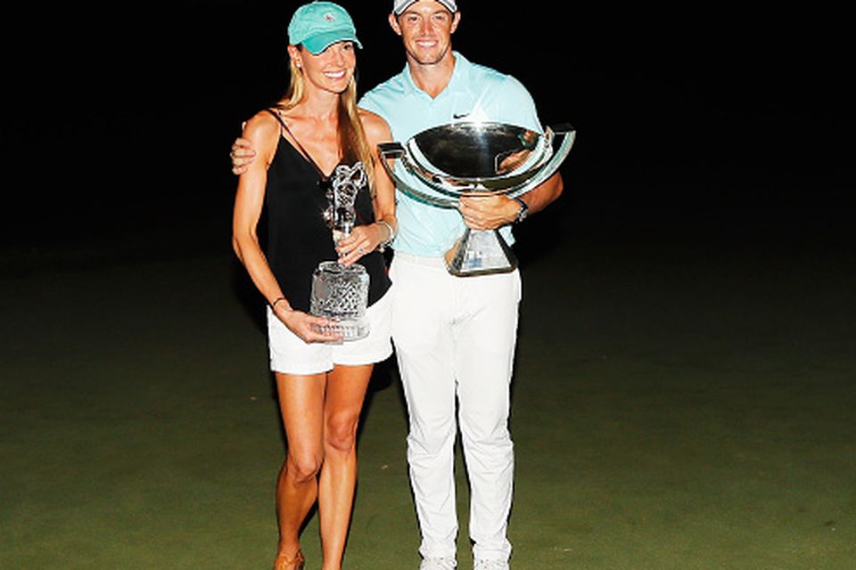 Rory McIlroy of Northern Ireland poses alongside his girlfriend Erica Stoll and the FedExCup and TOUR Championship trophies after his victory over Ryan Moore with a birdie on the fourth extra hole during the TOUR Championship at East Lake Golf Club on September 25, 2016 in Atlanta, Georgia. (Photo by Kevin C. Cox/Getty Images)