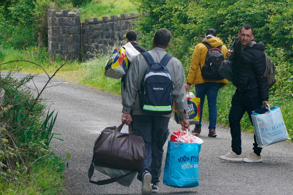 Asylum-seekers leaving Magowna House Hotel in Inch, Co Clare, and heading back to Dublin. Photo: PA