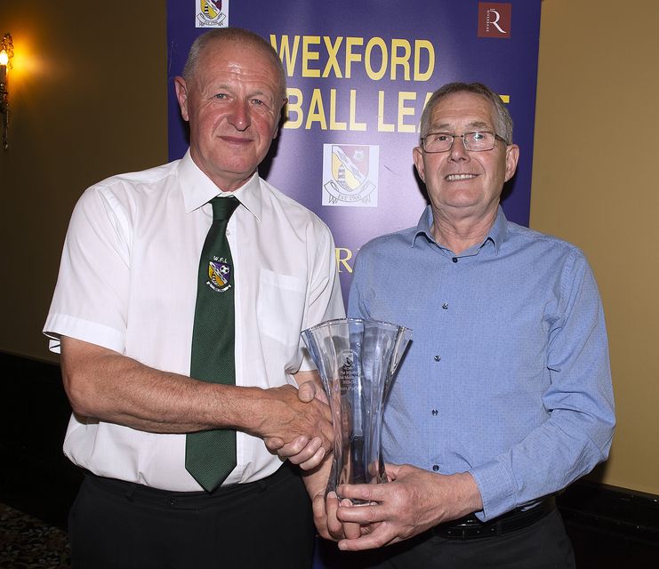 Seán Parker receiving the Pat Whitty Special Merit Award from league Chairman Denis Hennessy. Photo: Jim Campbell