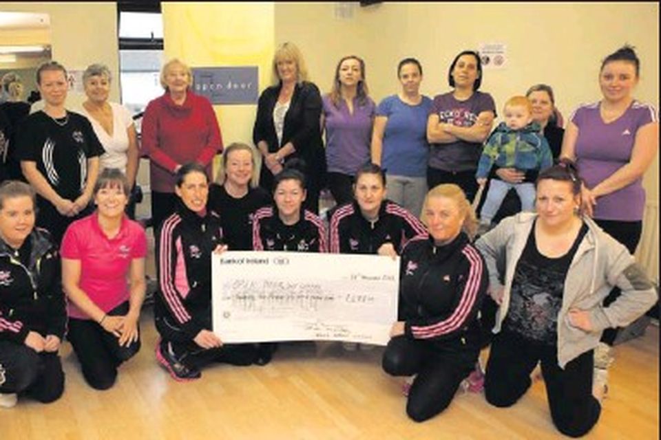 Workout Express ladies hand over cheque Irish Independent