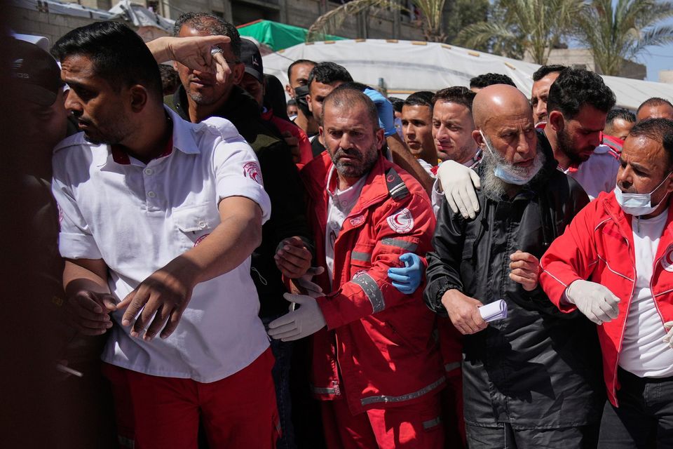 Mourners gather around the bodies of eight Red Crescent workers, recovered in Rafah a week after the Israeli attack. Photo:  AP