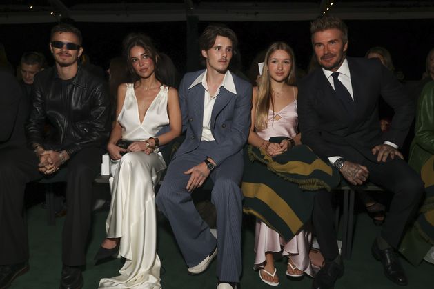 Victoria Beckham supported by family at Paris Fashion Week show